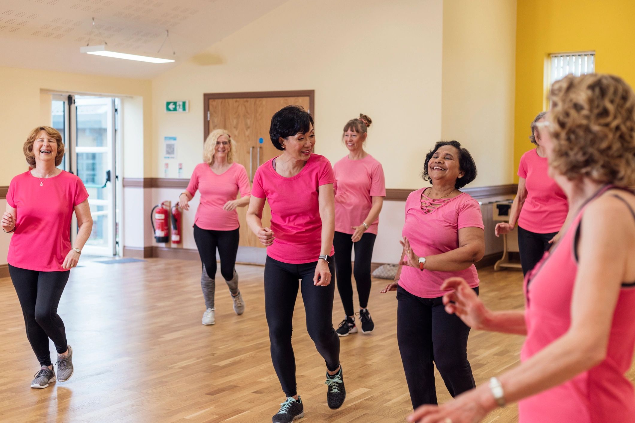 Group fitness class moving together in a studio